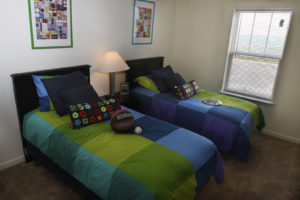 Bedroom at Stallion Pointe apartments in Everman, TX with two twin beds