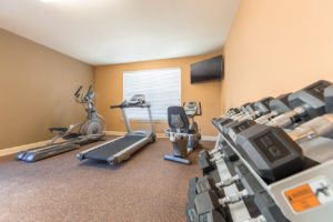 Stallion Pointe fitness center with a treadmill, elliptical, stationary bike, and free weights